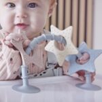 Shnuggle stick n play on highchair with girl close up view square